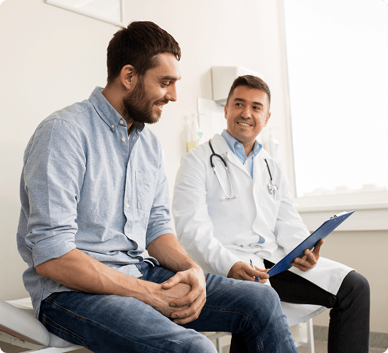 A man and a doctor sit together in a clinic
